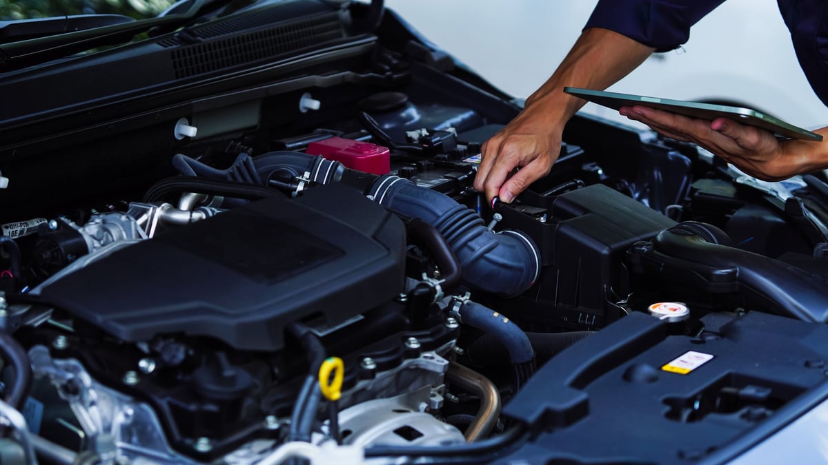 Auto mechanic hands using wrench to repair auto engine