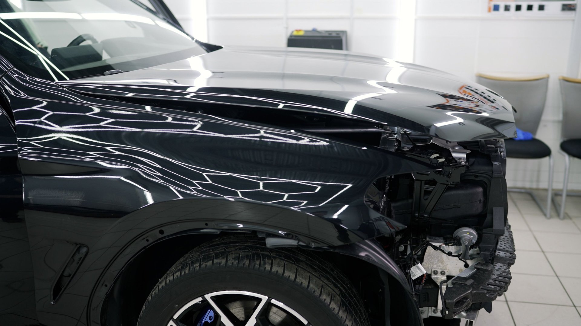 Damaged car being restored to its original condition by skilled mechanics in a specialized workshop